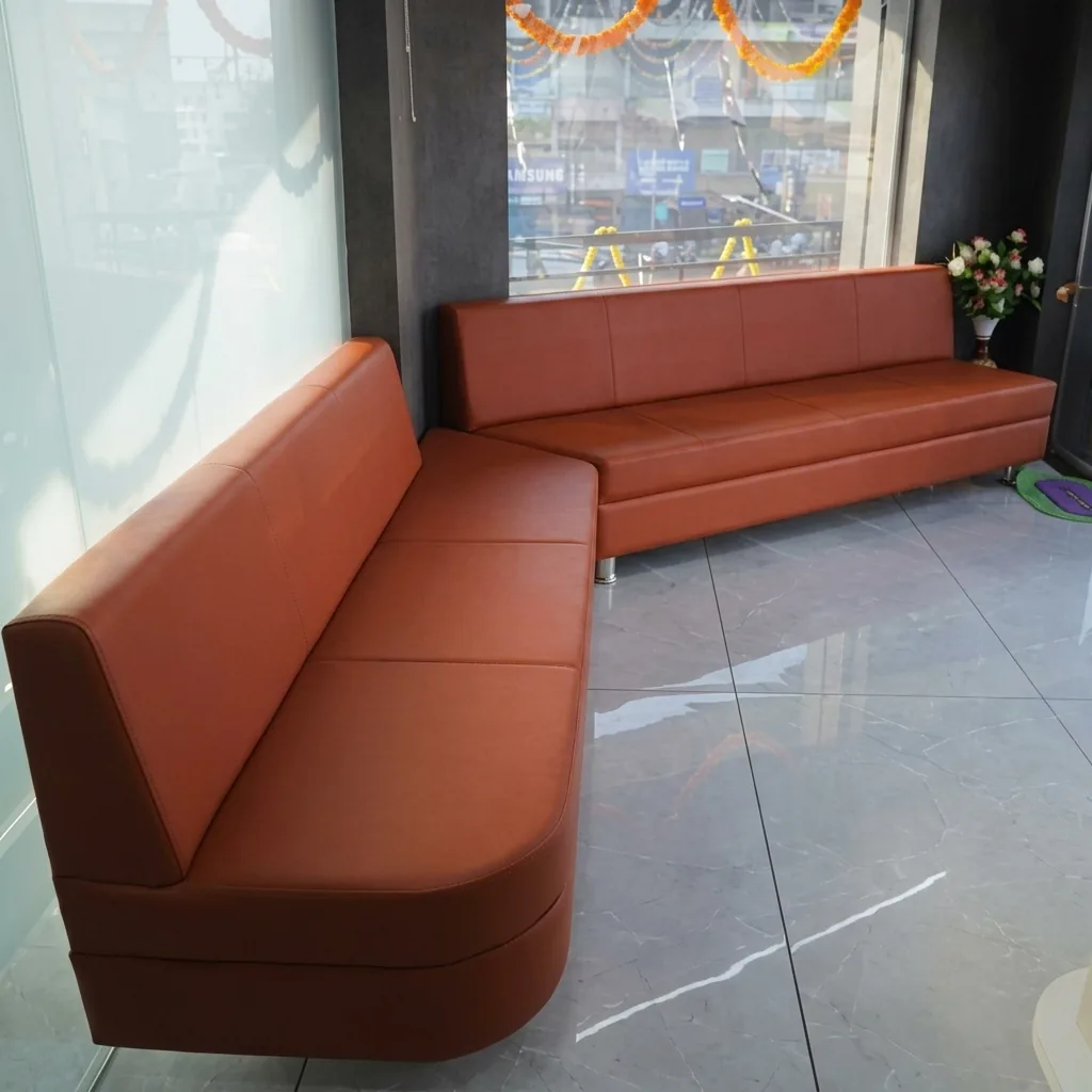 Comfortable patient waiting lounge with leather seating at Pramukh Dental